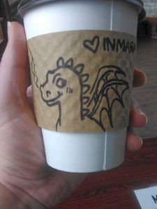 photo of a dragon illustration on a drink sleeve with Inmara written on it